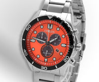 A Citizen watch with a orange dial and a steel band on a light silver and white background. ,
