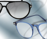 A pair of black sunglasses and a pair of blue eyeglasses on a light blue and white background. ,