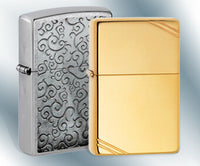 A silver Zippo next to a brass zippo on a light blue and white background. ,